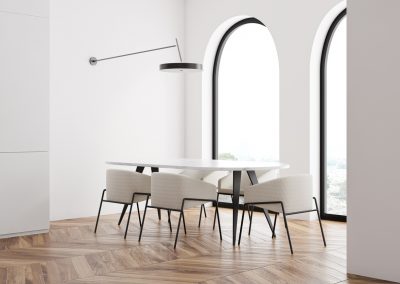 White dining room corner with arched windows