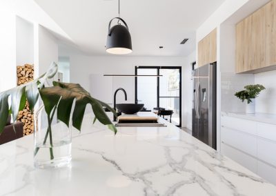 Kitchen marble bench close up with black hanging pendant