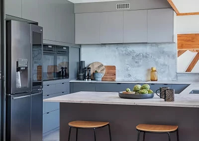 Modern kitchen featuring sleek cabinetry and stone benchtops