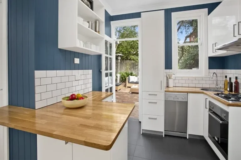 Original kitchen with worn benchtops before renovation in Burleigh Heads