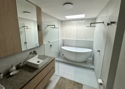 Completed bathroom with freestanding bath, vessel basin and matte black fixtures at Palm Beach